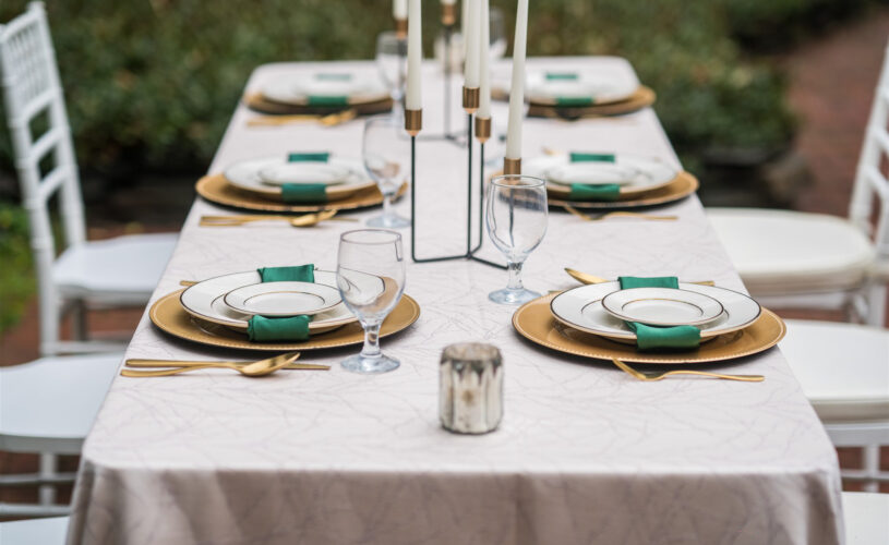 Green themed table setting with beige linens