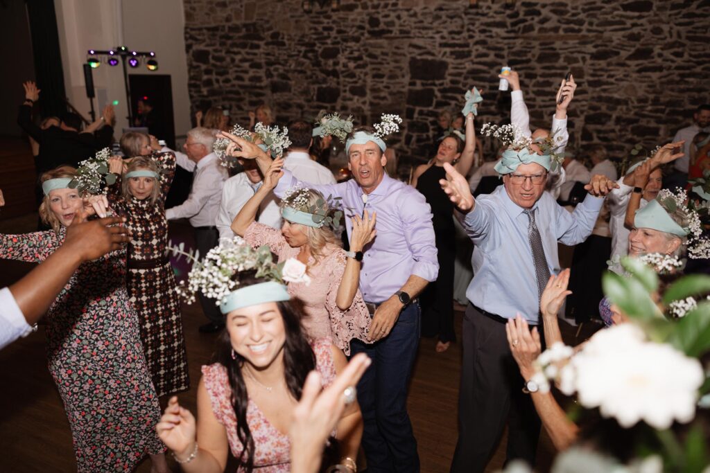 Guests dance with head pieces on.