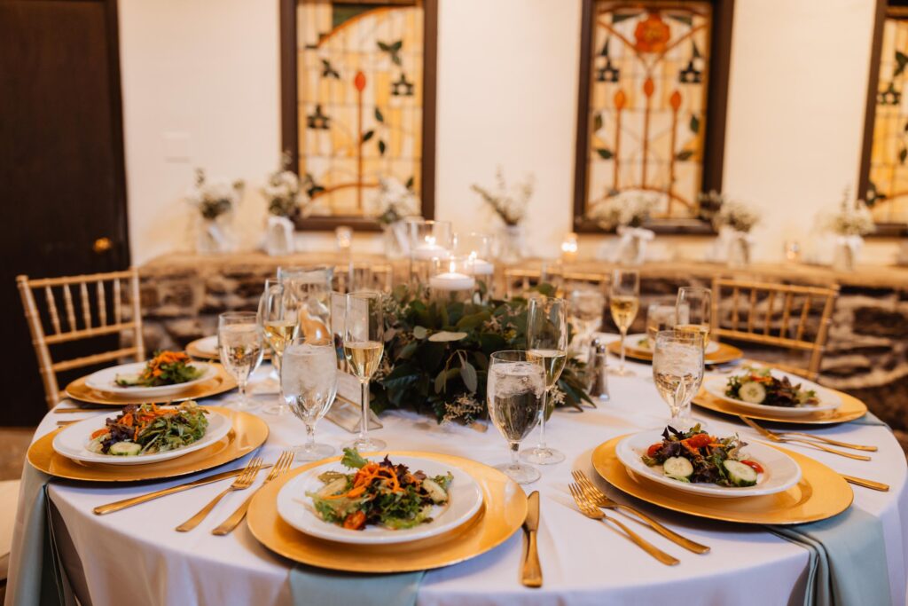 Dinner table with place settings and centerpiece.