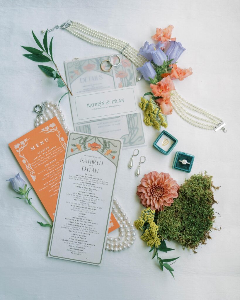 Invitation and details with moss and flowers.