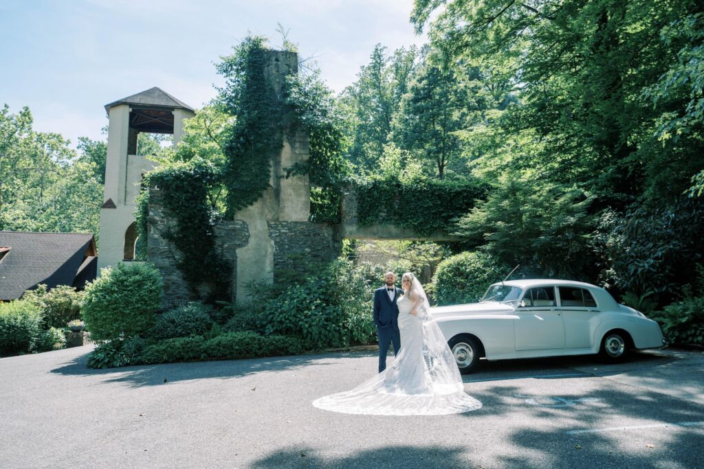 Newlyweds standing in front of The Old Mill.