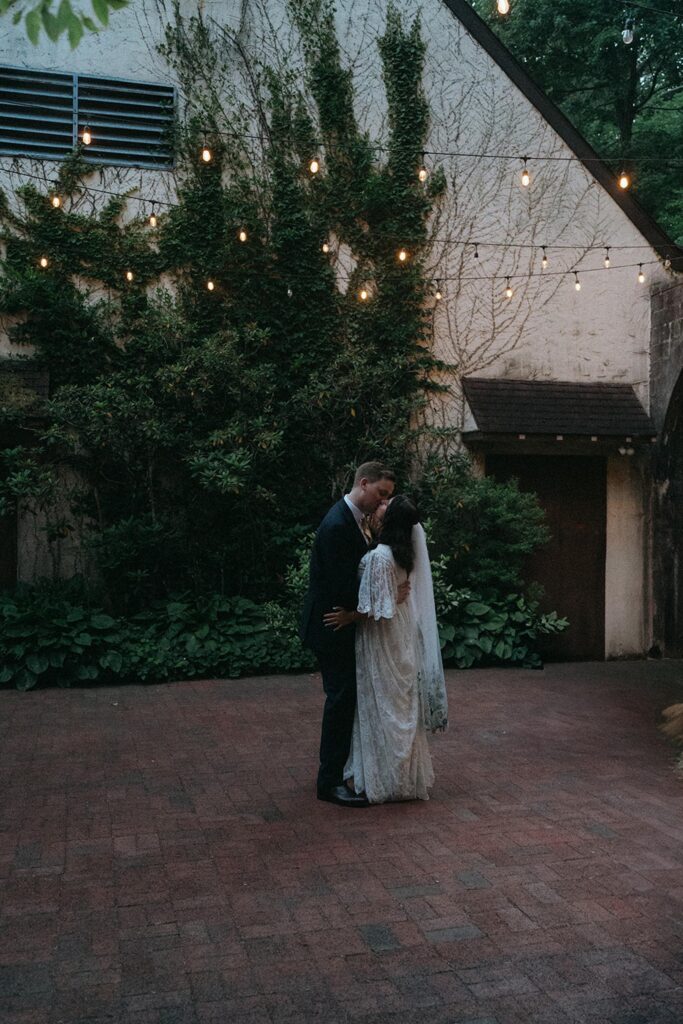 Newlyweds dance in the garden.