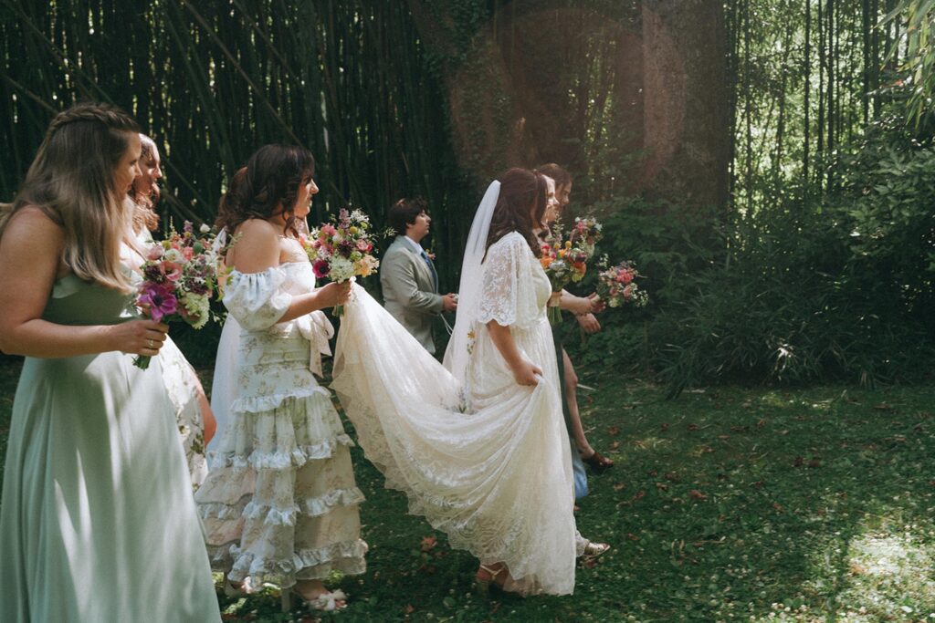 Bride walking with her bridesmaids in the garden.