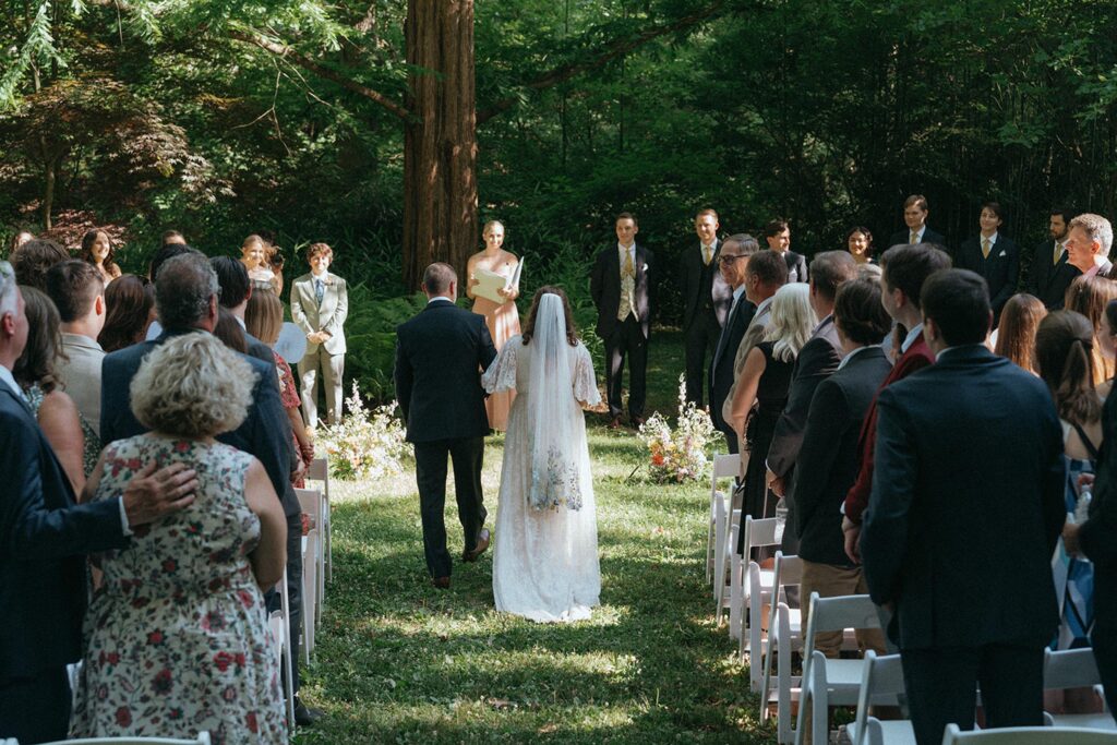 Bride walking down the aisle towards her groom.